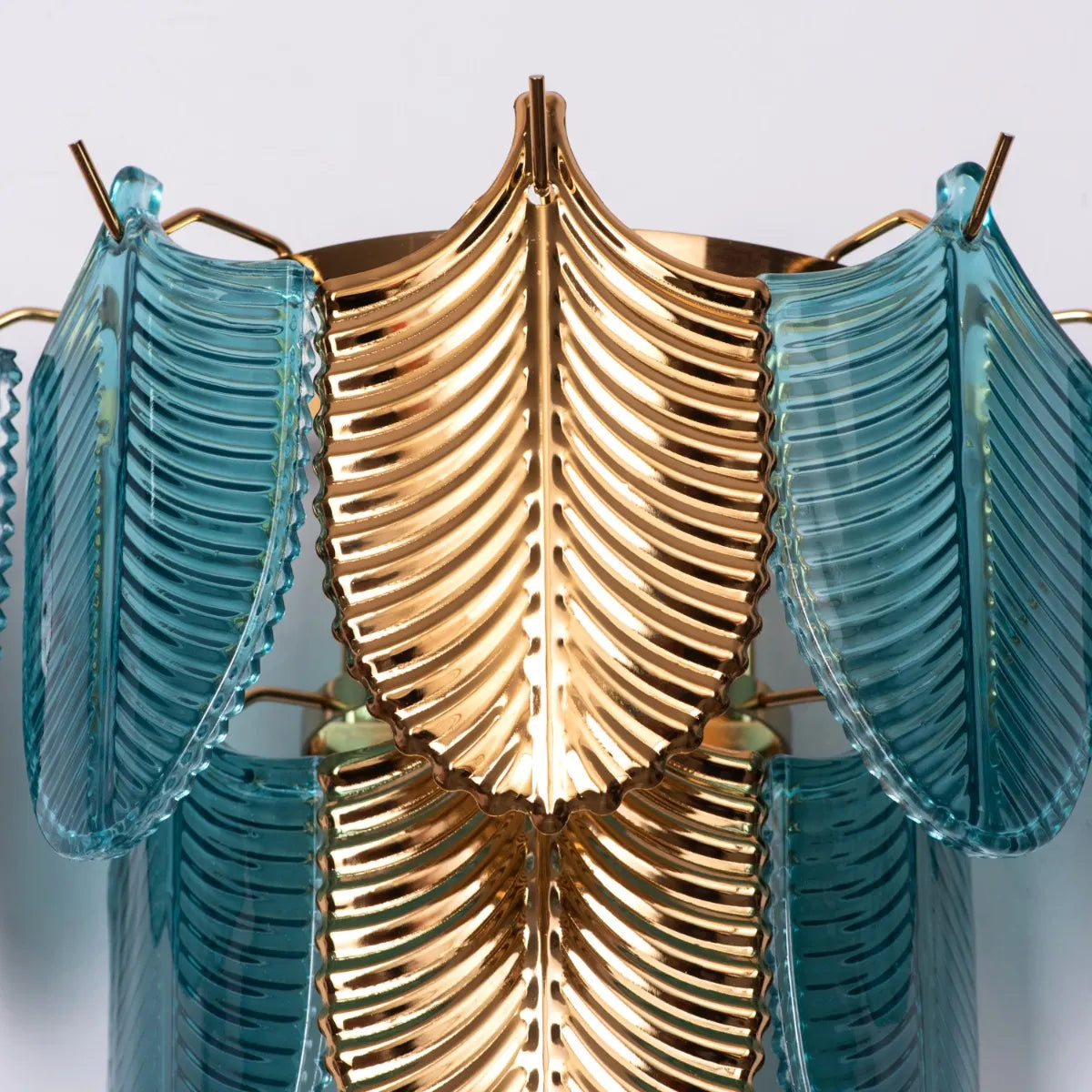 Magic In Milan glass wall light casting a warm glow in a modern living room.