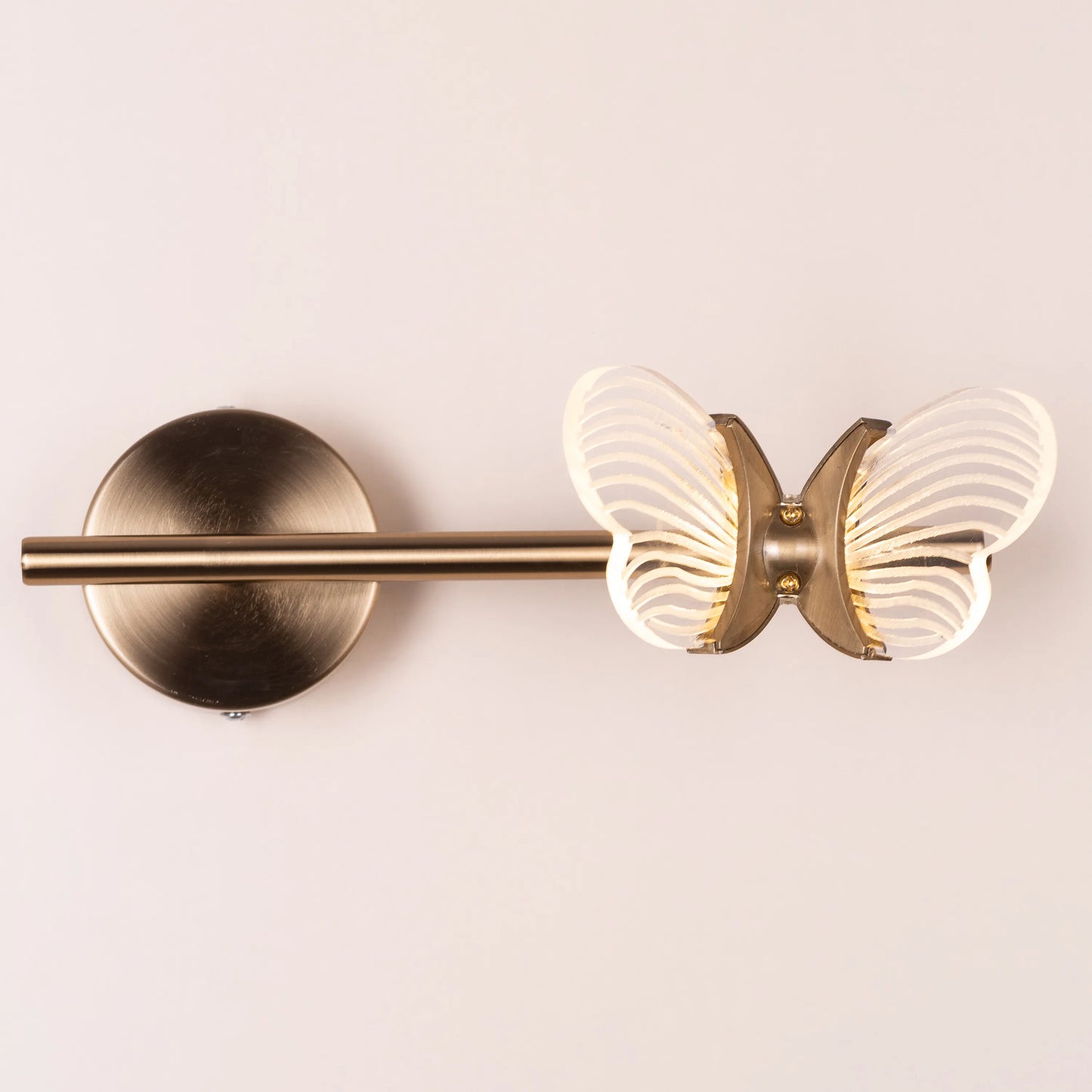 Butterfly Kisses Wall Light - Delicate and enchanting wall lighting fixture featuring a cluster of elegant metal cutouts that form the wings of a butterfly, creating a mesmerizing play of light and shadow.
